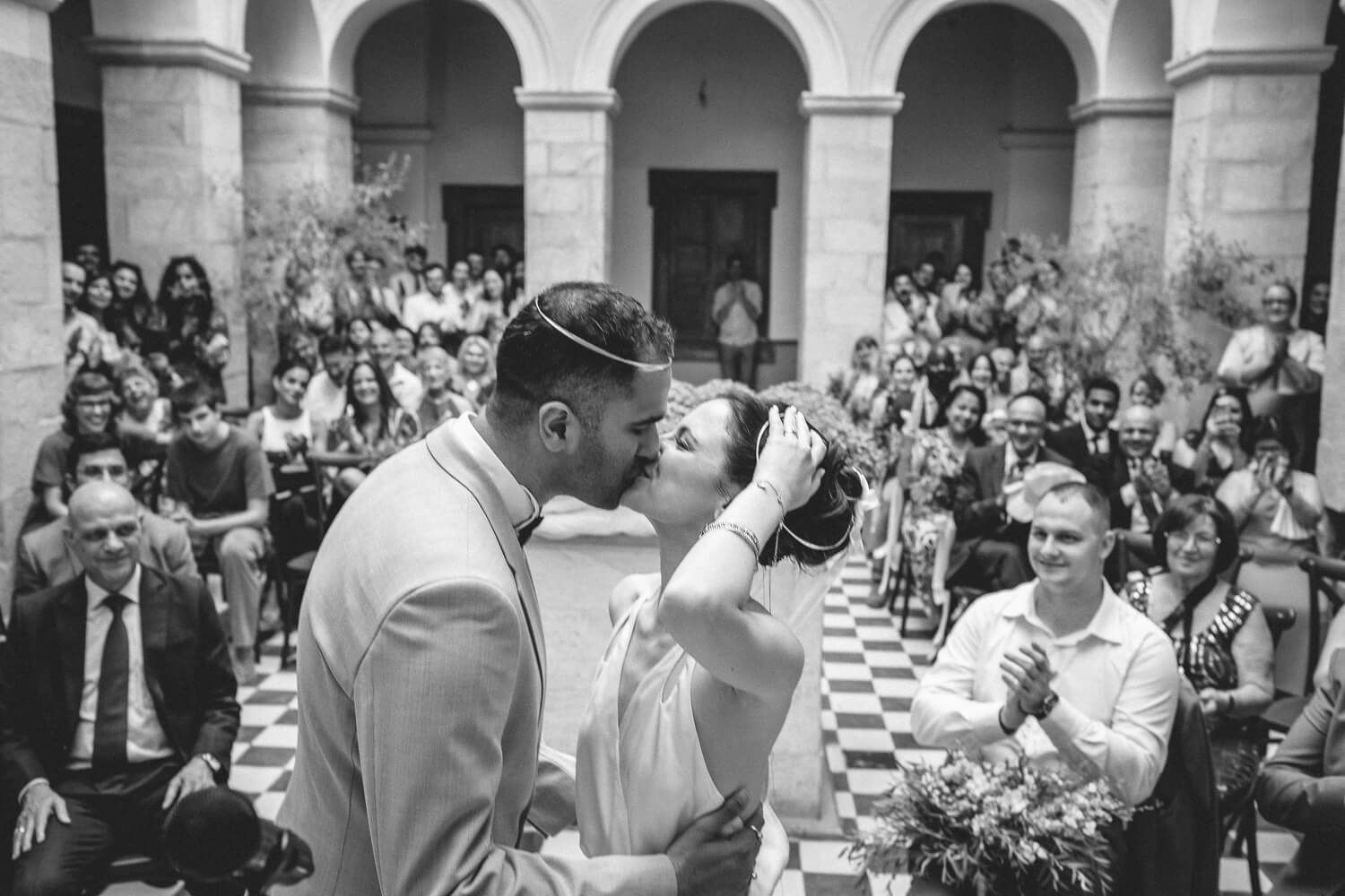 Newlyweds sharing their first kiss at Ermoupolis Town Hall