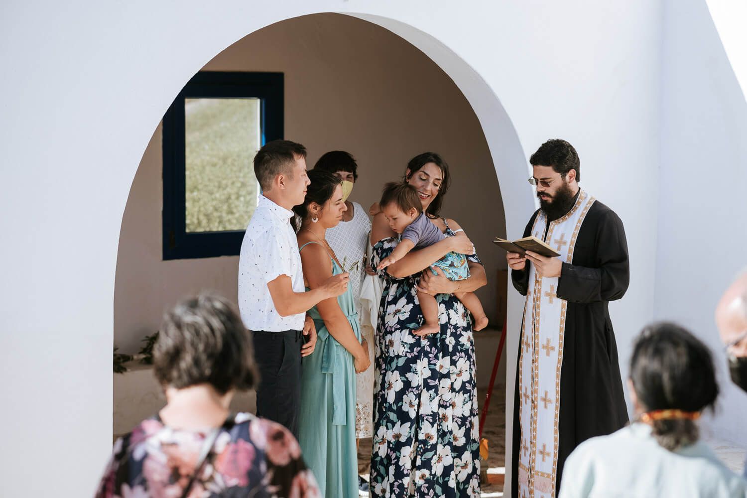 Godparent and baby moment during the sacrament