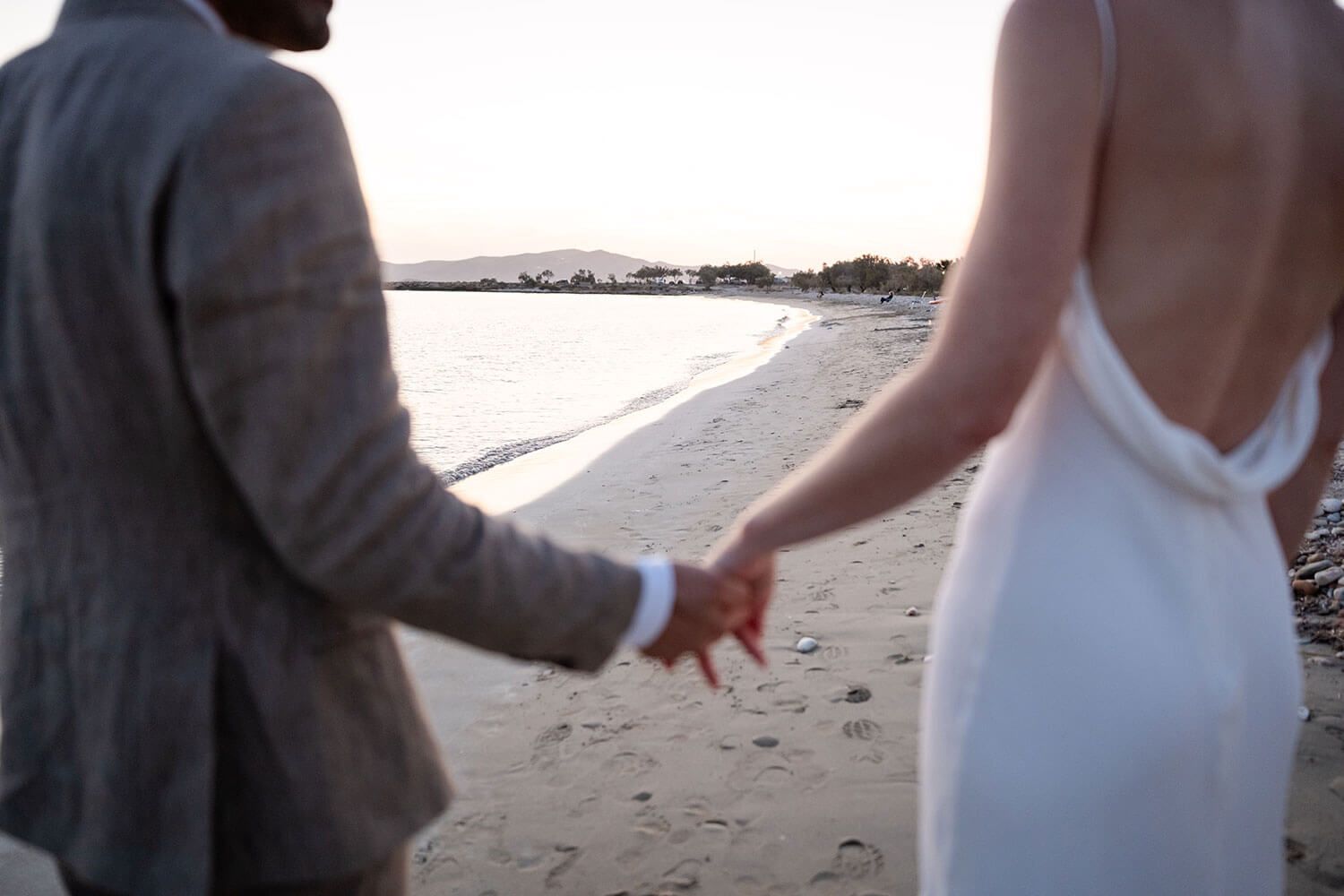 Romantic golden hour couple portraits on the beach in Aliki Paros