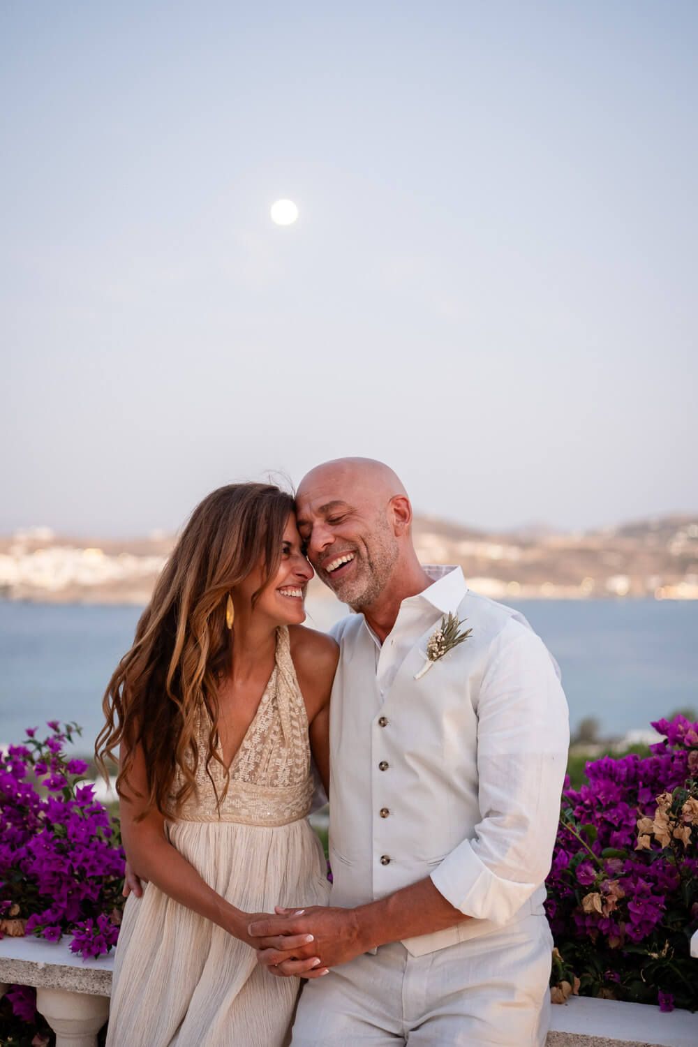 Kathy and Dean, the newlyweds, laughing under the full moon