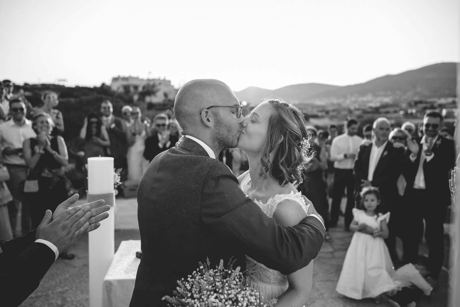 Newlyweds sharing their first kiss outside the traditional church