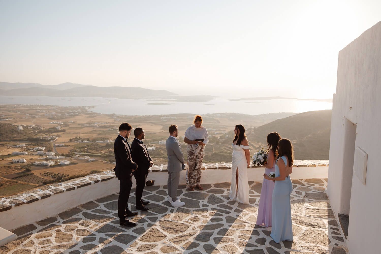 Dreamy sunset light hitting the bride and groom during an elopement in Paros.