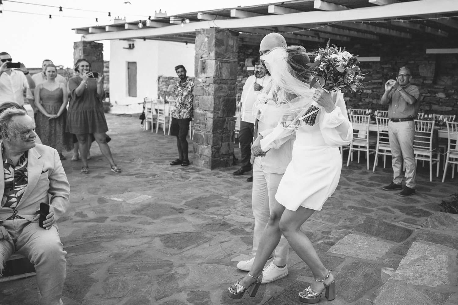 Couple entering the ceremony at the Secret View venue in Paros island Greece