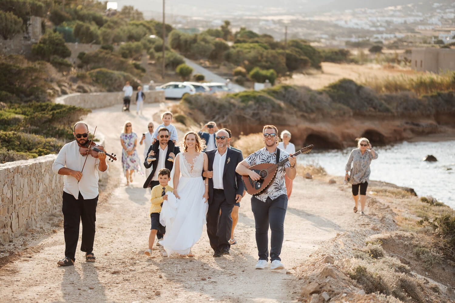 Traditional Greek musicians playing as the bride walks up the hill in Pyrgaki Paros
