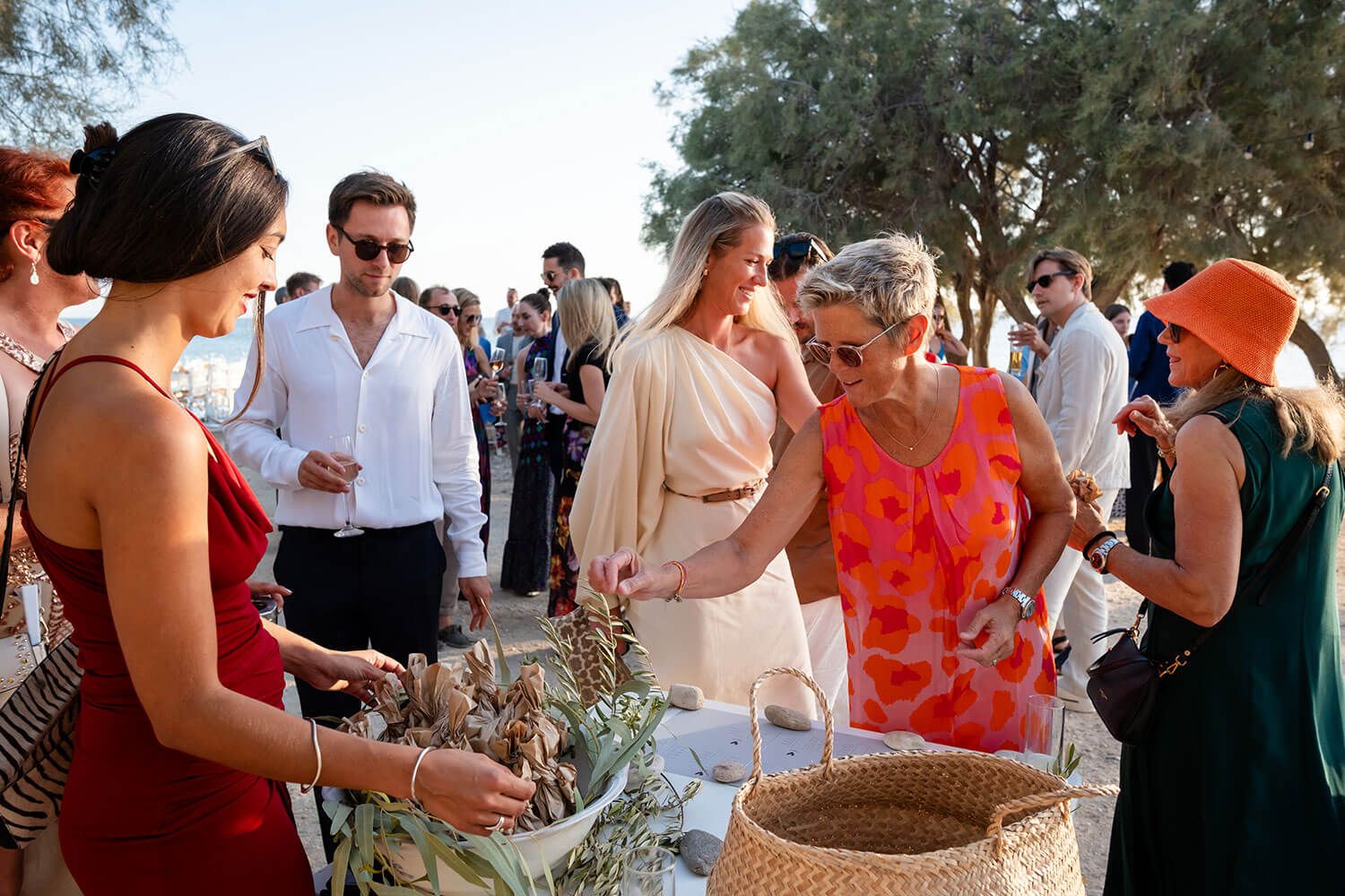 Guests gathering for a relaxed beach party before a Paros destination wedding