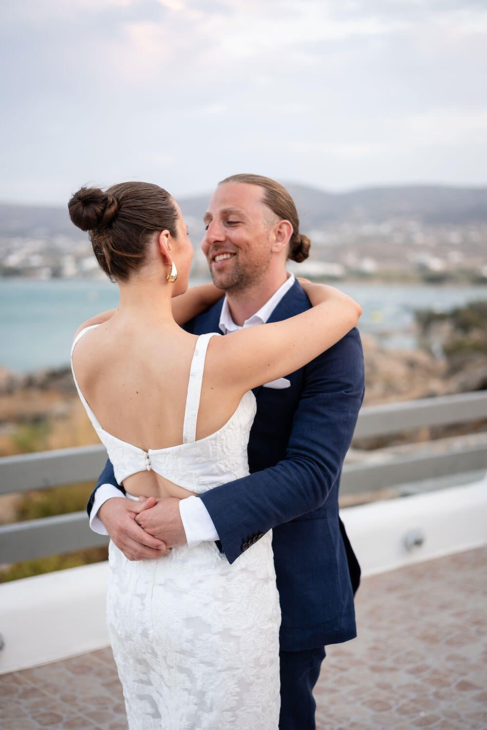 Romantic embrace of the married couple right after their Paros ceremony