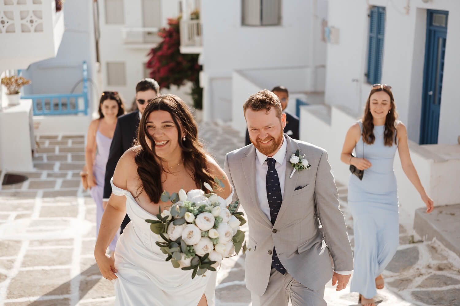 Hand in hand walk through white cobblestone streets