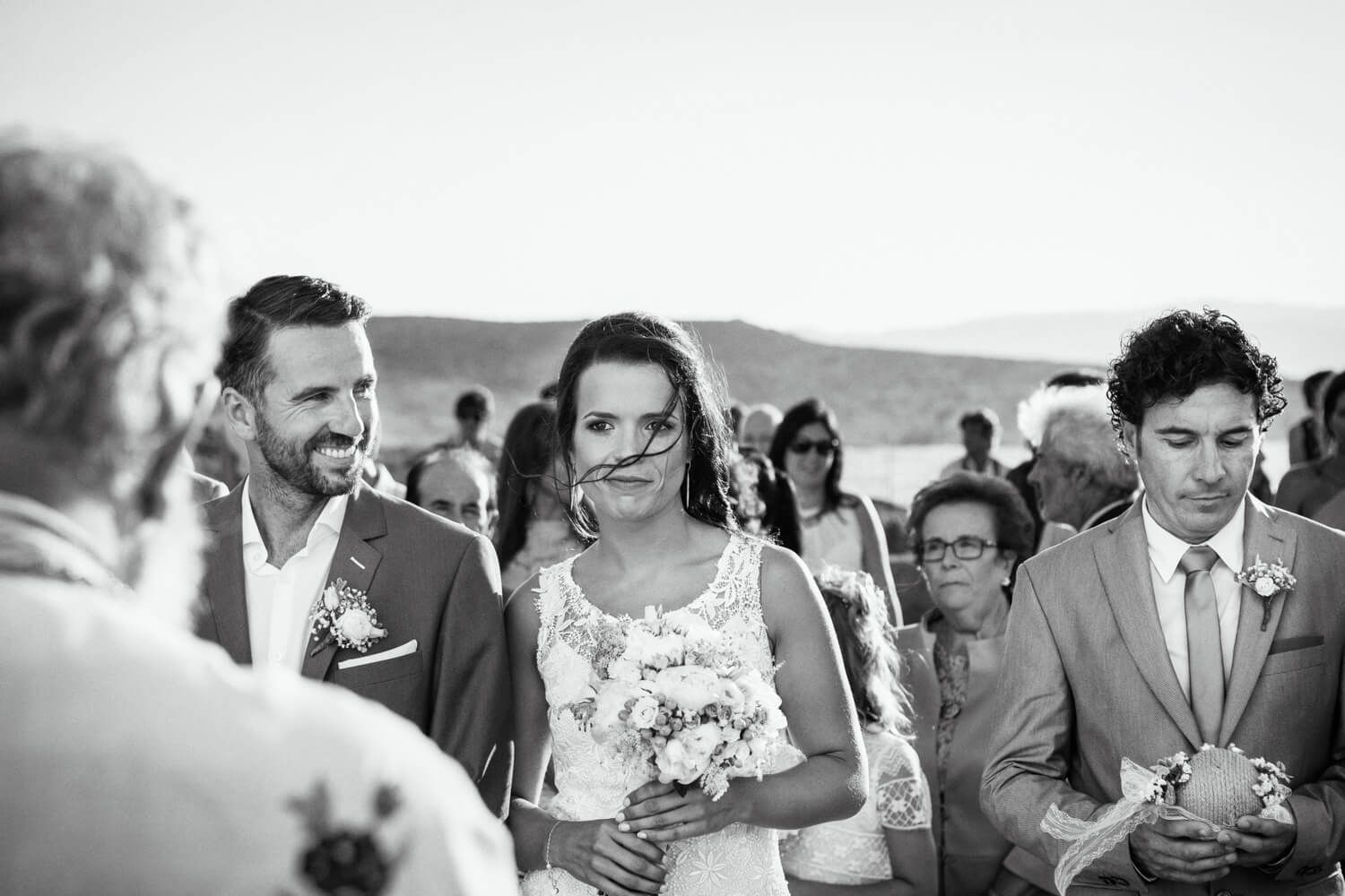 Bride and groom during a Wedding ceremony at Agios Konstantinos church by the sea in Milos