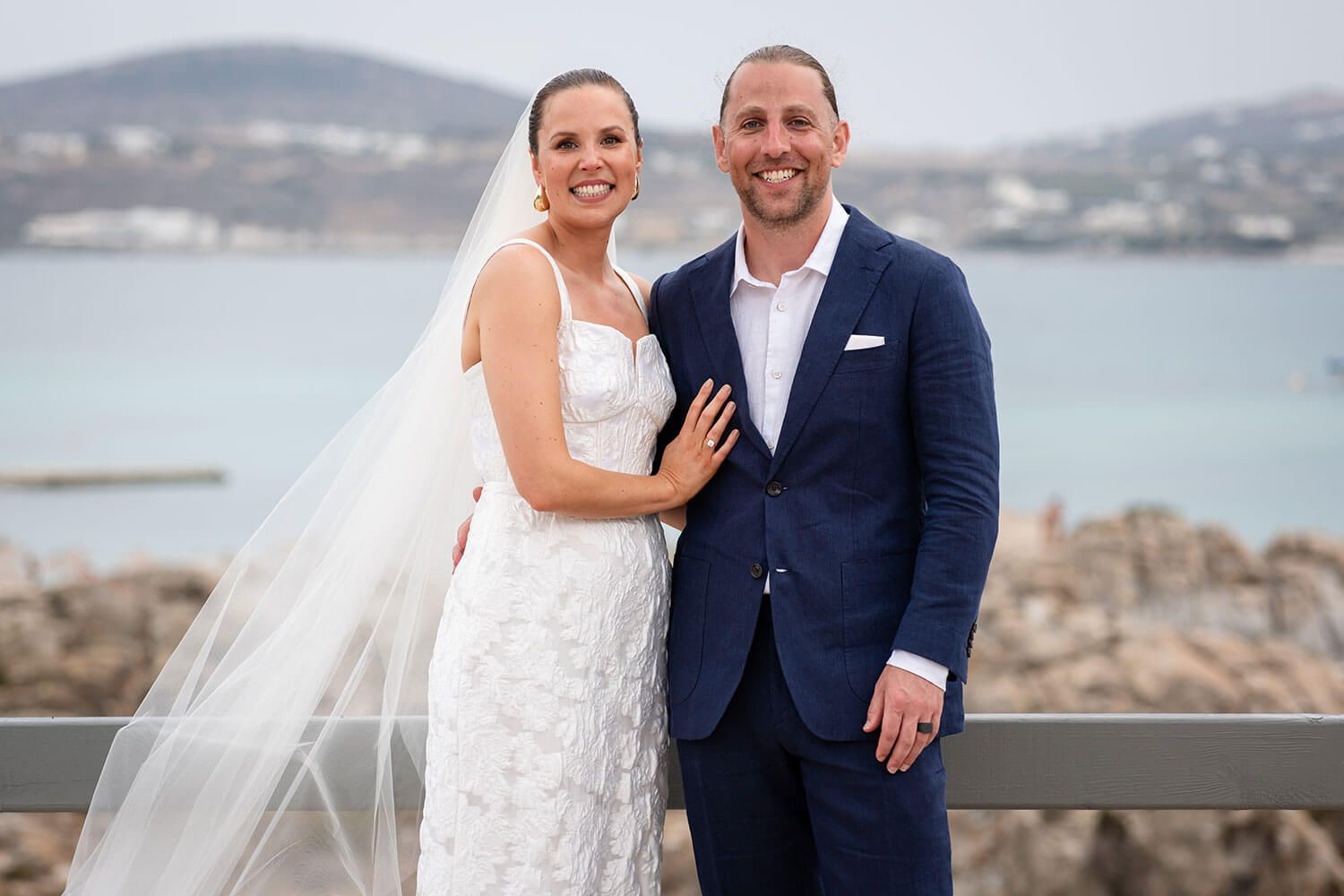 Romantic embrace of the married couple right after their Paros ceremony