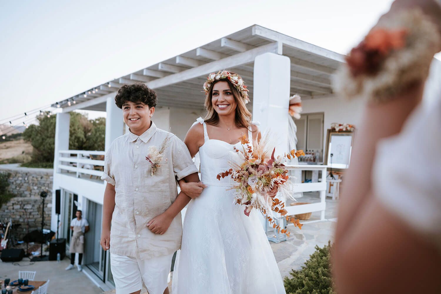 Boho bride Meli walking down the aisle at her Greek island wedding