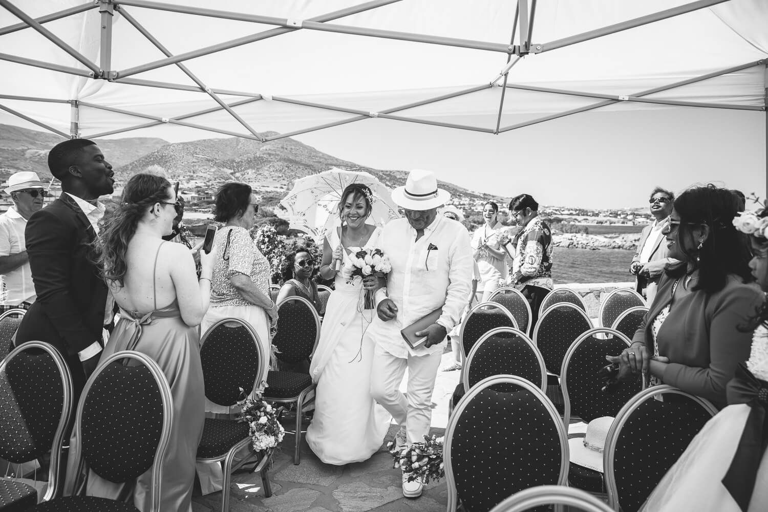 Father escorting the bride at a symbolic wedding ceremony at Pyrgaki Paros