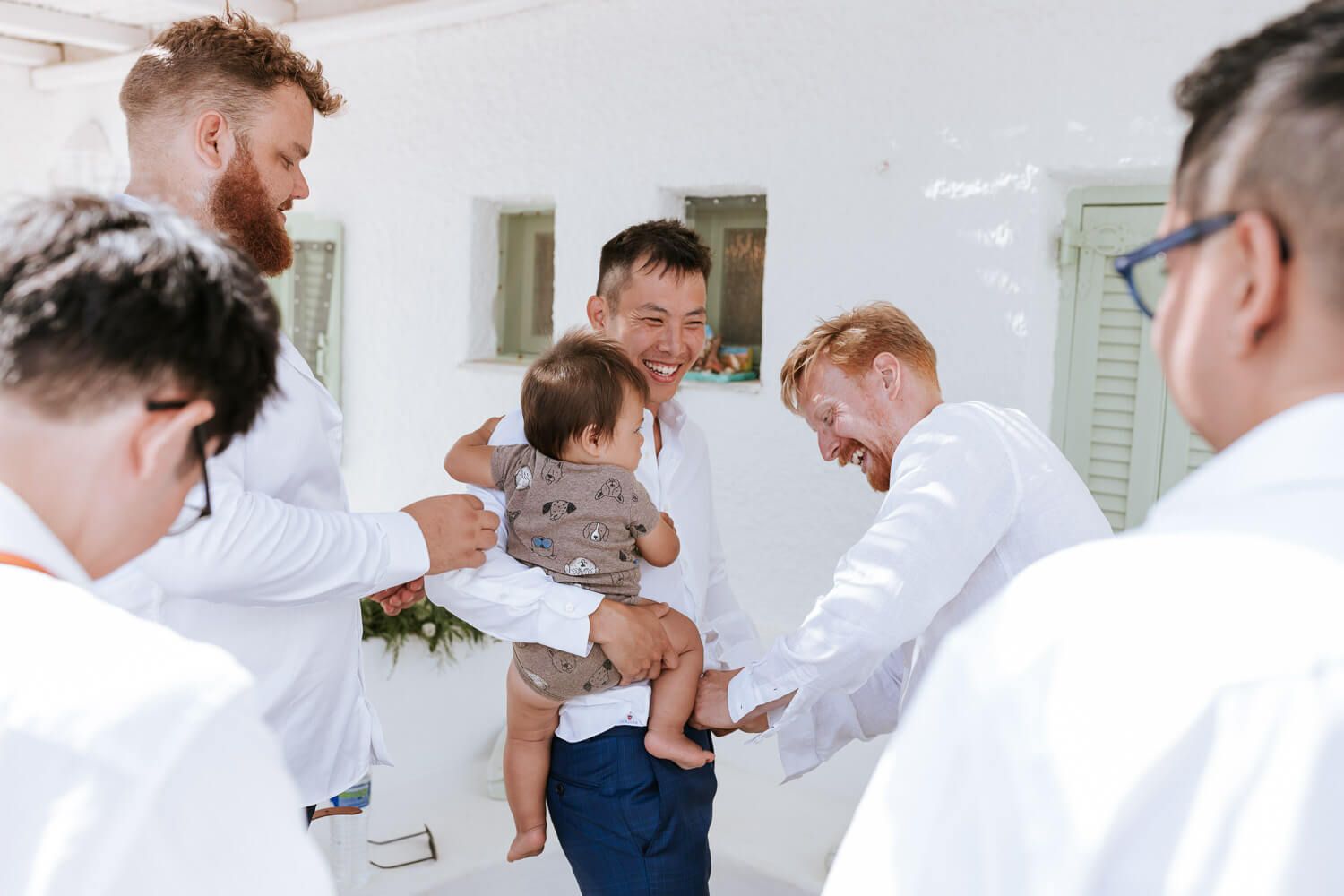 Groom getting ready with his baby son in Antiparos
