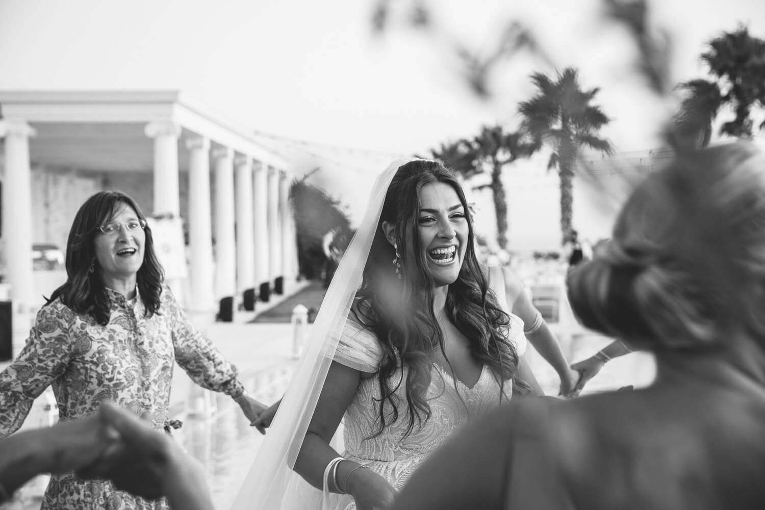 Guests dancing in circles for the traditional Hora at Paros wedding