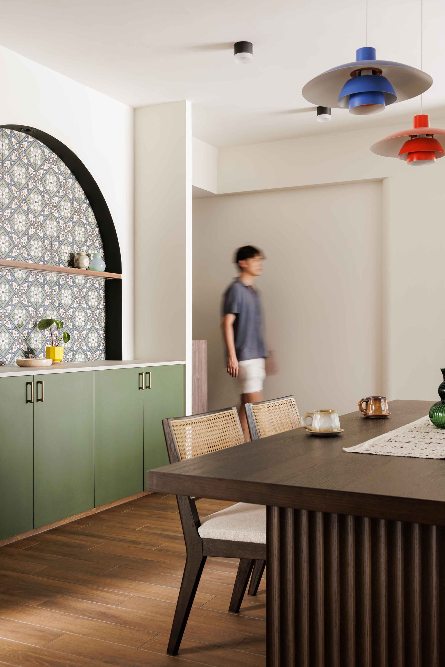 Sequence of dining room shots showing green cabinets and arched alcove with motion blur of someone walking past.