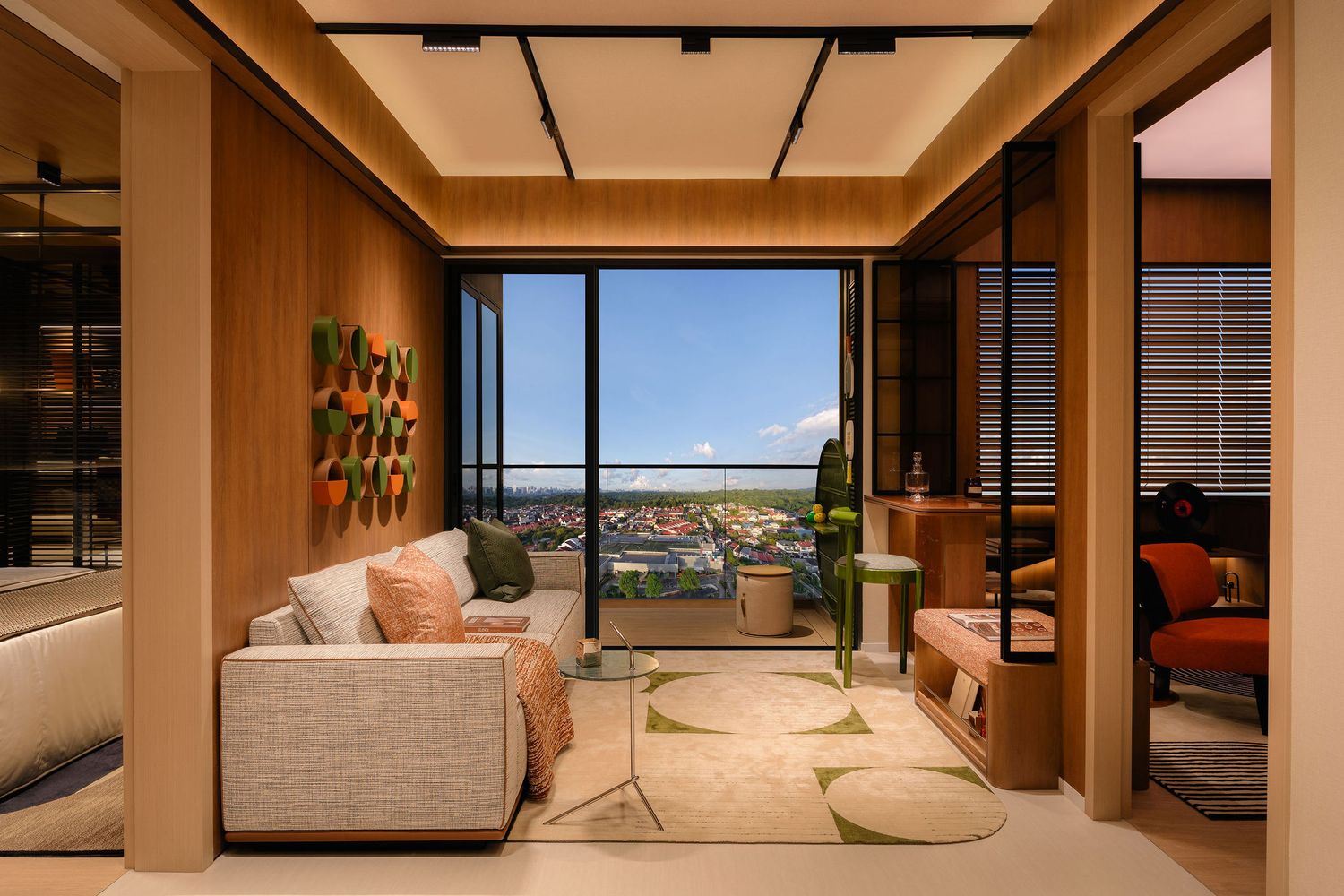 Modern apartment living room with wood paneling, cream sofa, and floor-to-ceiling windows opening to a balcony with sweeping city views.