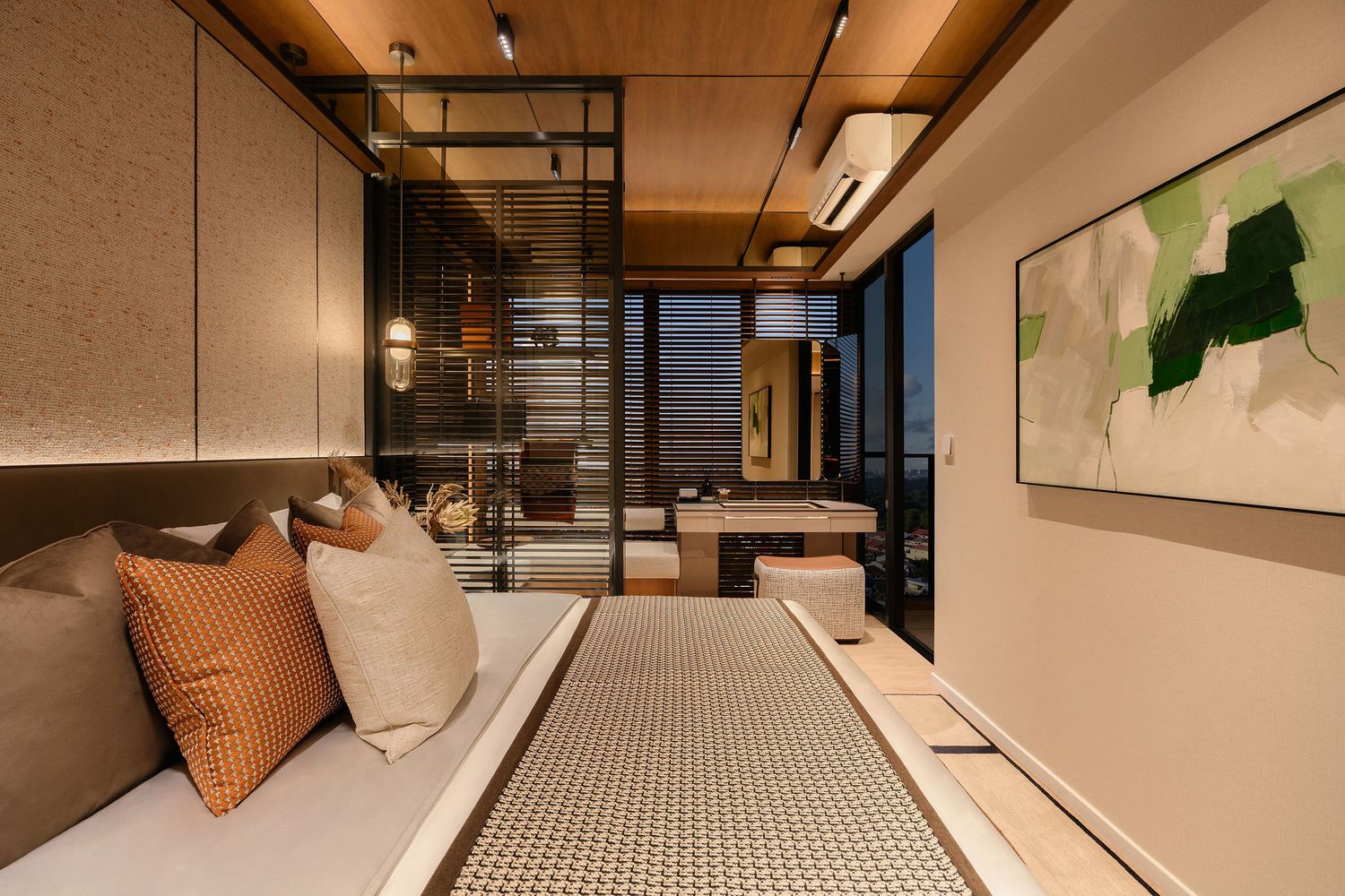 Modern bedroom with a cushioned daybed, orange and beige pillows, wood ceiling, glass partition and abstract green wall art at dusk.