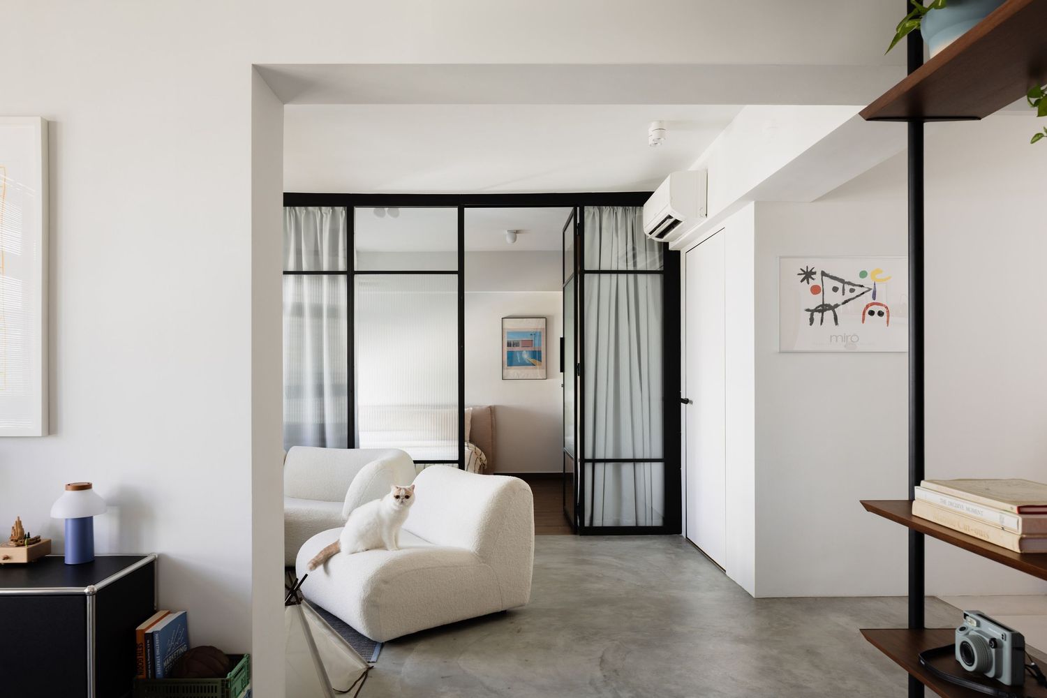 Light and airy modern interior with sleek furnishings and floor-to-ceiling windows illuminating a minimalist living space.