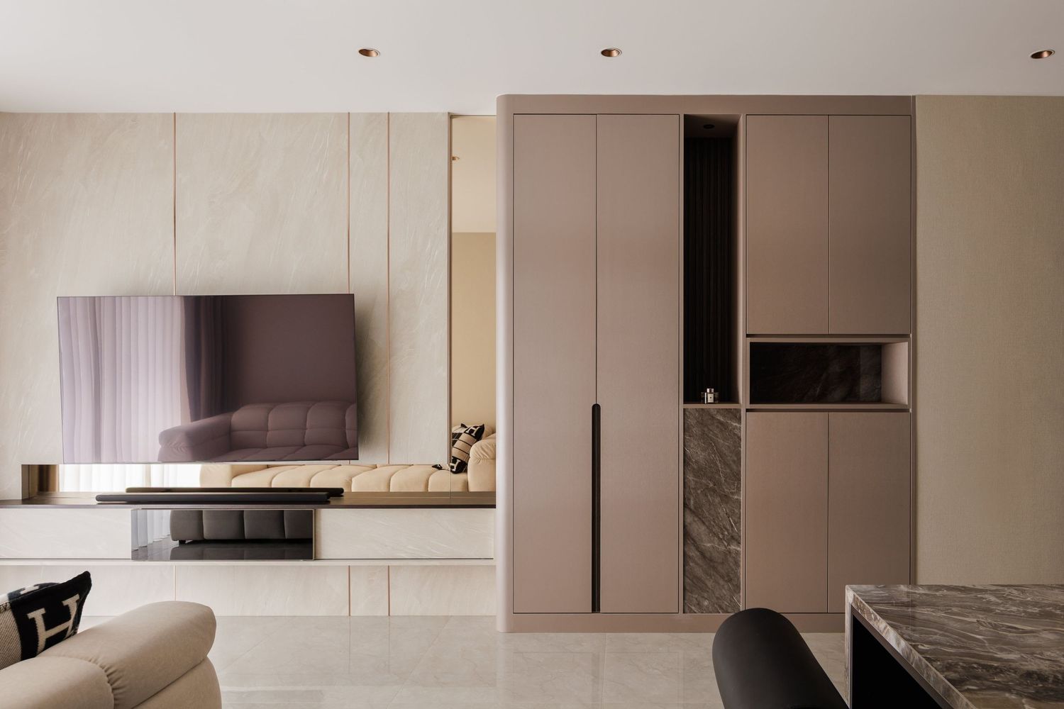 Modern white and beige kitchen interior with sleek cabinets, marble countertops, and minimalist design elements.