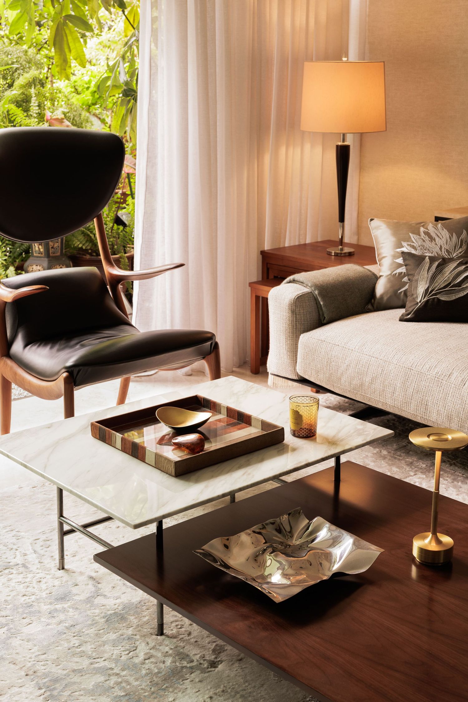 Modern spa room with massage tables, white linens, wooden floors and soft lighting creates a tranquil wellness atmosphere.