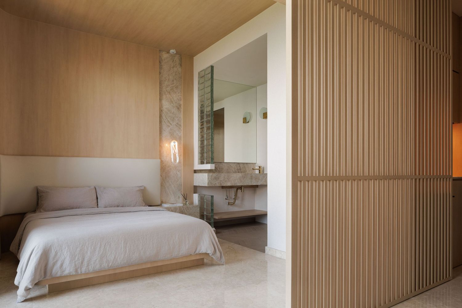 Modern minimalist bedroom interior with wooden slat walls, white bedding, and clean lines.