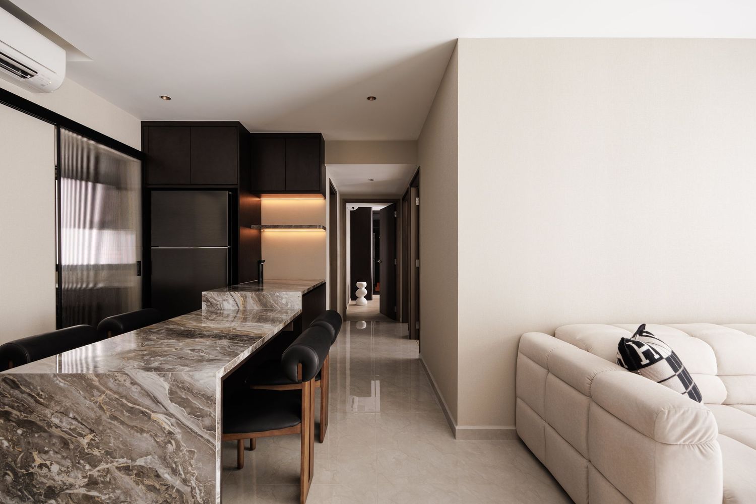Modern minimalist interior design features sleek white walls and furniture in an open concept living space.