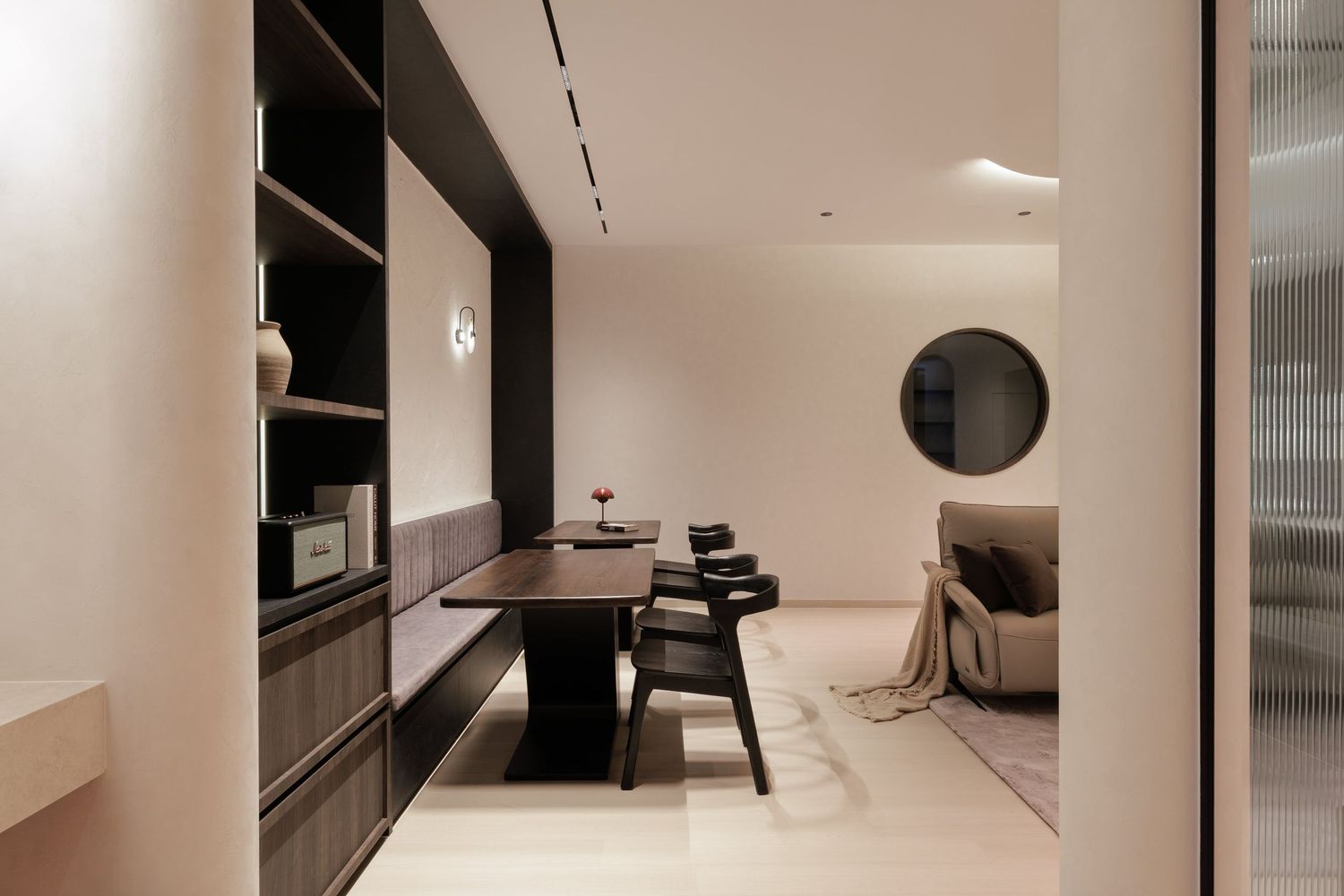 Modern minimalist white bedroom interior with sleek black accents and built-in storage solutions.