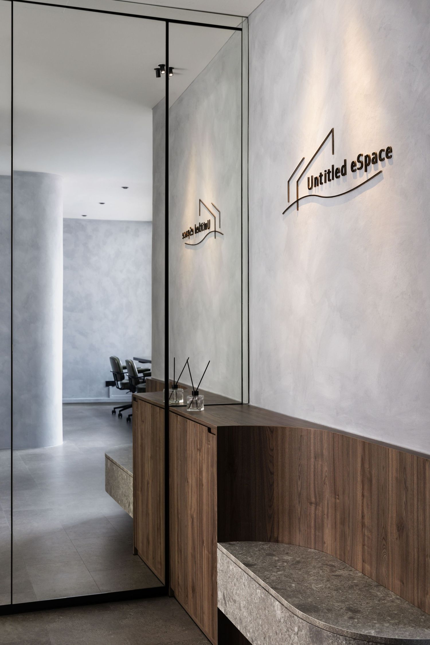 Modern office reception area with wooden panels, mirrored wall and minimalist 