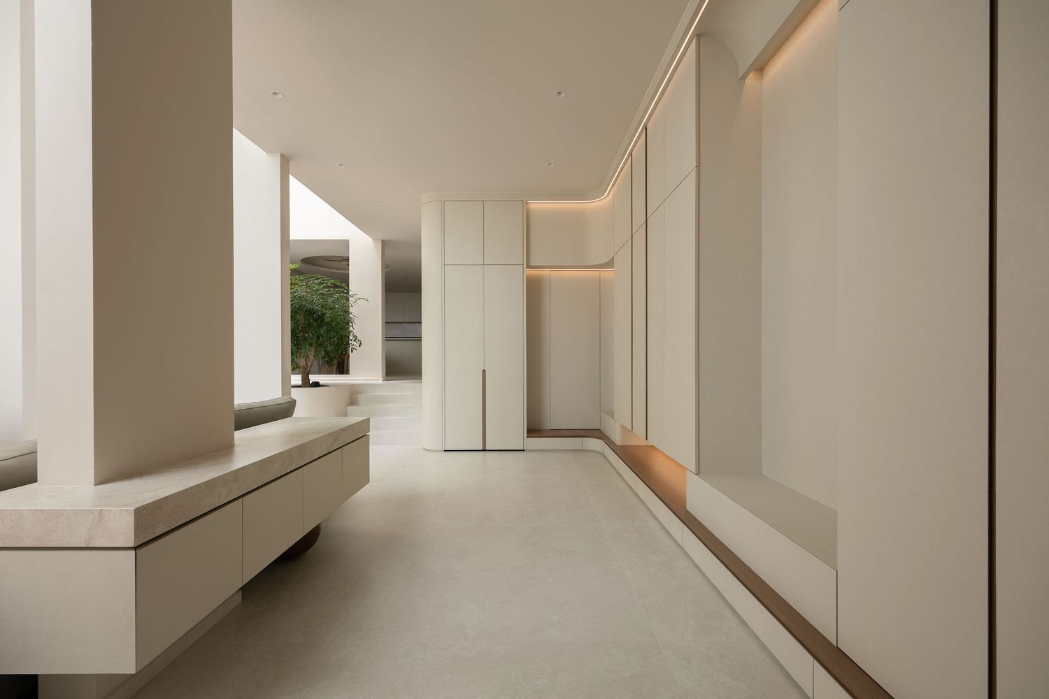 Minimalist white hallway with sleek built-in storage, subtle lighting, and a serene, modern interior design aesthetic.