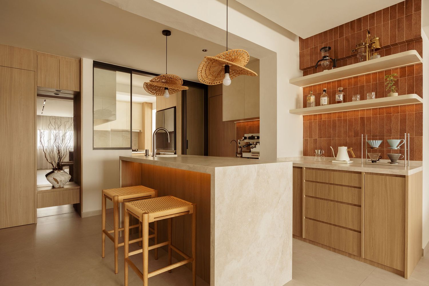 Modern kitchen with wooden bar stools, marble island, warm wood cabinetry, open shelving, and pendant lights.