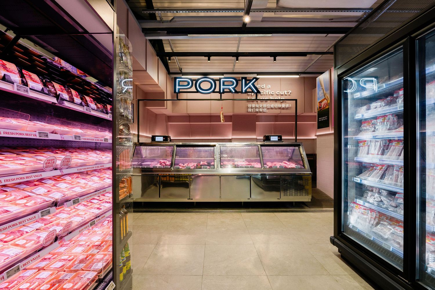 Supermarket pork section with refrigerated shelves of packaged fresh pork cuts and a butcher service counter beneath a lit PORK sign.