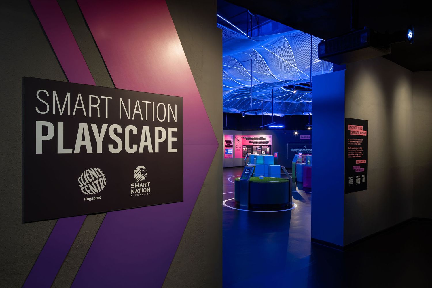 Smart Nation Playscape interactive exhibit entrance with vibrant purple and blue lighting at a science museum.