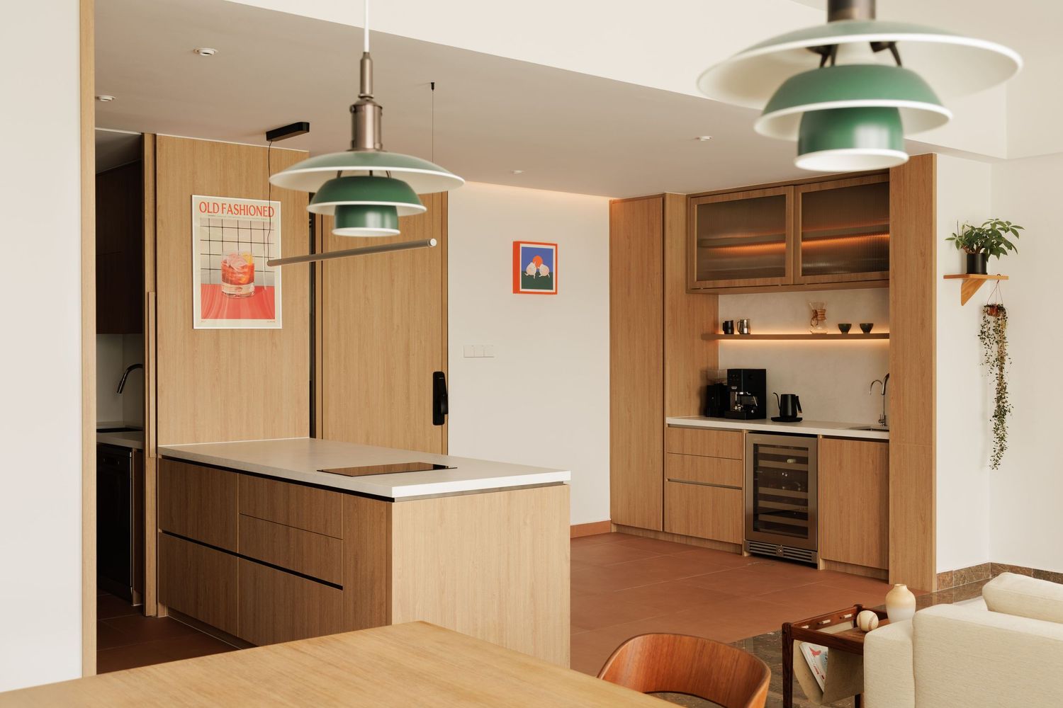 Modern minimalist kitchen with pendant lights, wood cabinets, and sleek appliances in a neutral color palette.