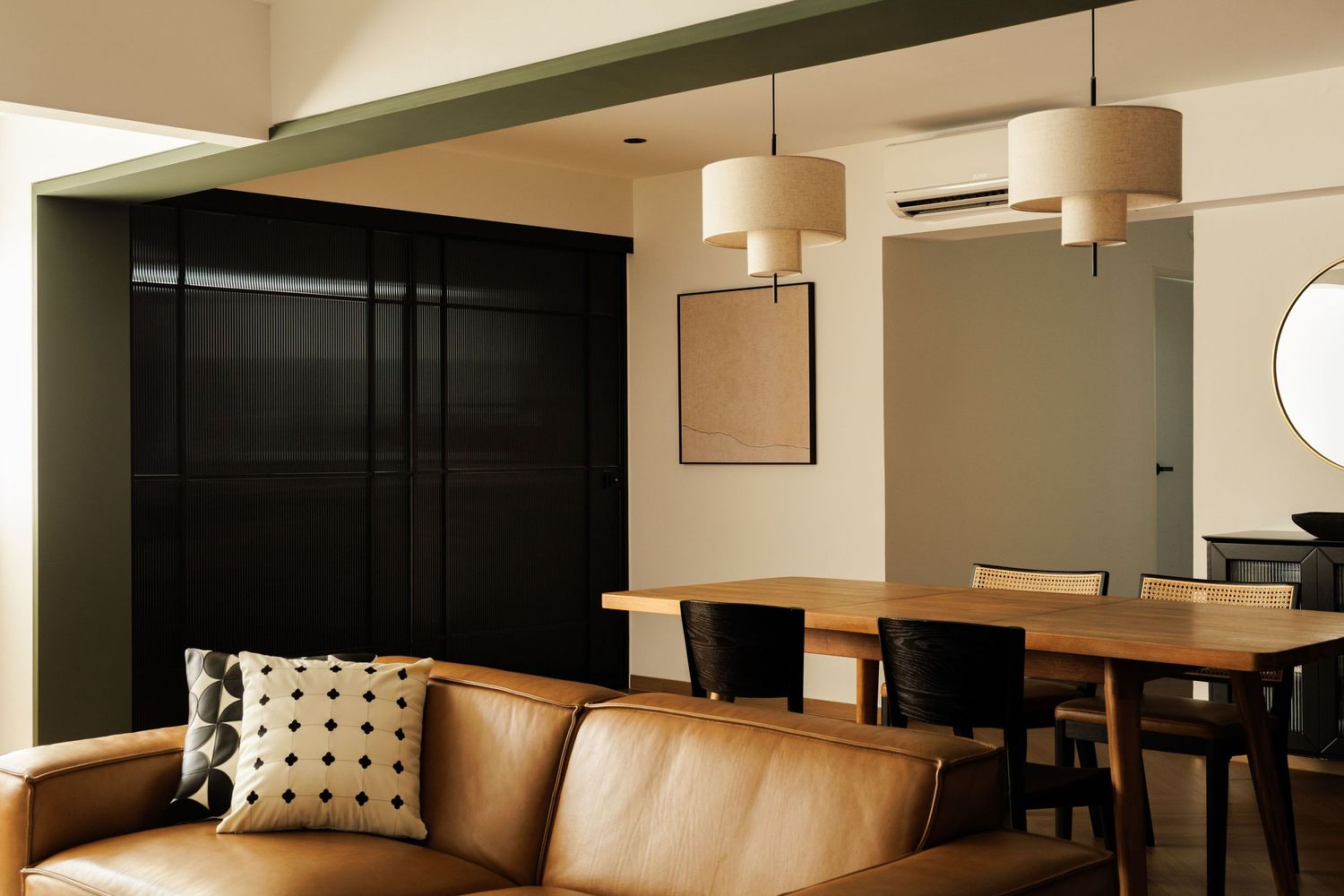 Modern minimalist interior design featuring pendant lights, wooden furniture, and polished concrete floors in an open space.