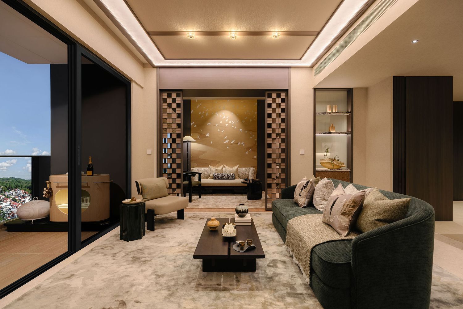 Luxury living room with a curved dark green sofa, marble coffee table, gold accent wall and floor-to-ceiling windows with a balcony view.