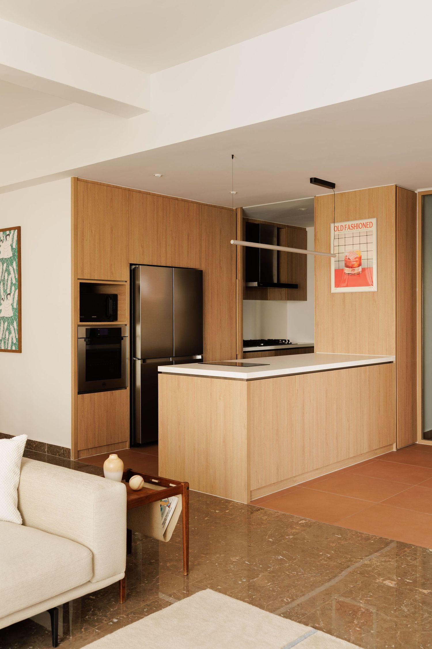 Modern apartment interior with wood paneling, white counters, and built-in furniture showing different angles of the space.