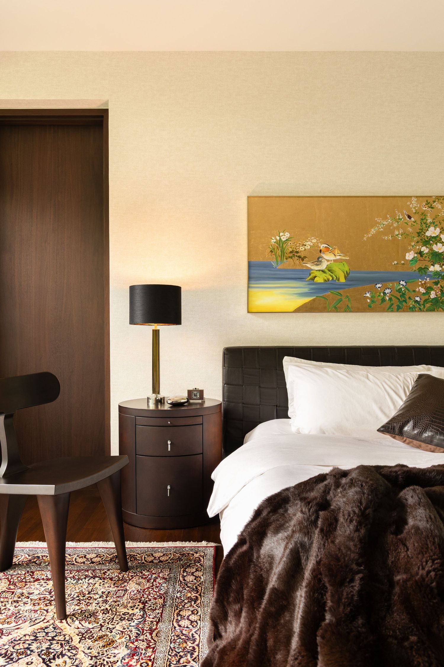 A series of modern hotel room interior photos showing dark wood furniture and a patterned area rug.