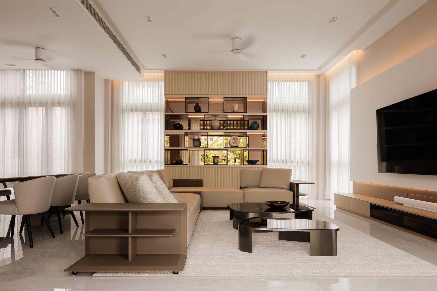 Modern minimalist apartment interior with beige tones features floating shelves and clean lines throughout the open space.