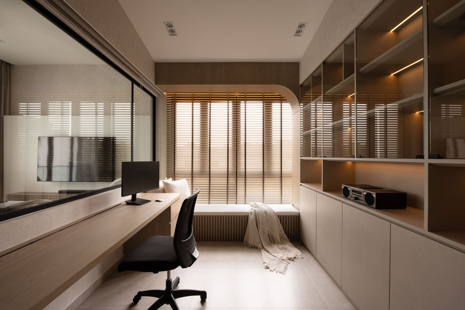 Modern home office interior with minimalist furniture, glass partitions, and warm wood accents creates a sleek workspace.