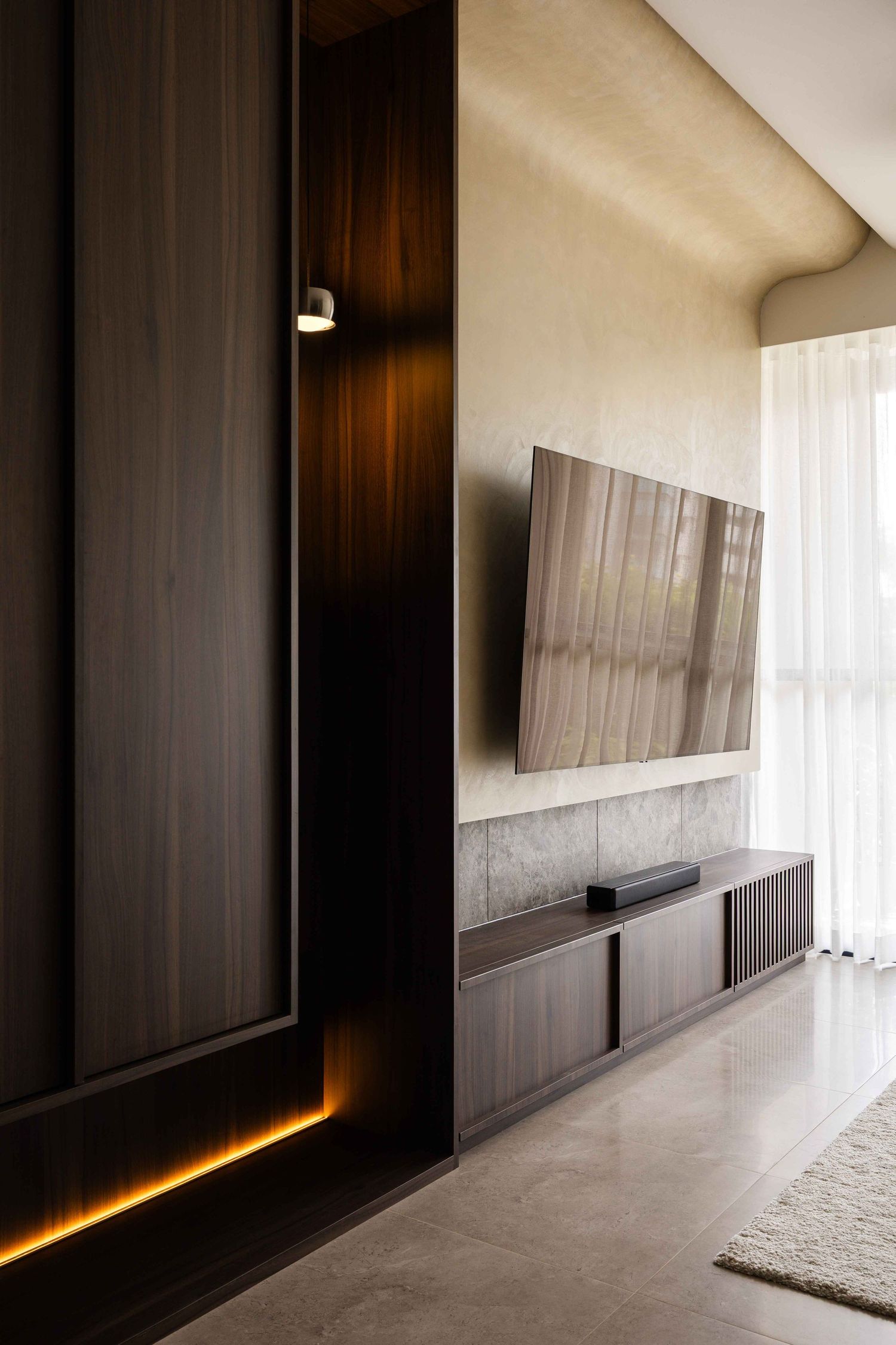 Modern interior hallway features dark wood paneling with dramatic ambient lighting and white curtains along minimalist design.