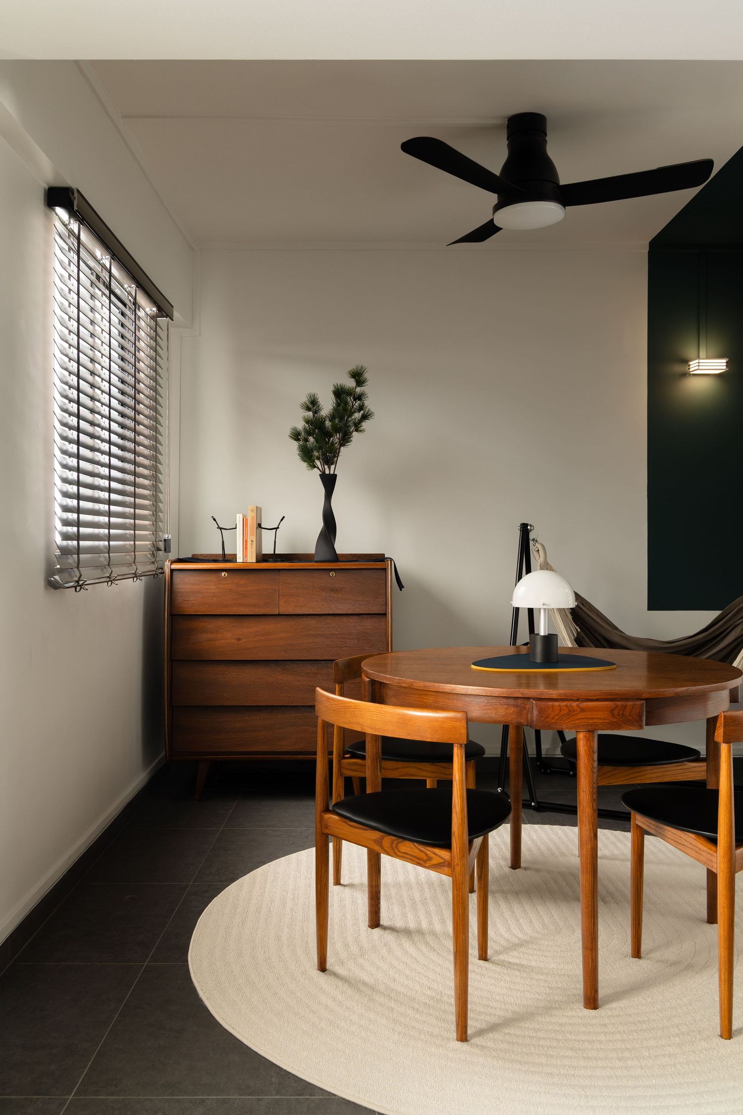 Modern wooden coffee table set on dark floor with white rug and minimalist decor in contemporary living space.