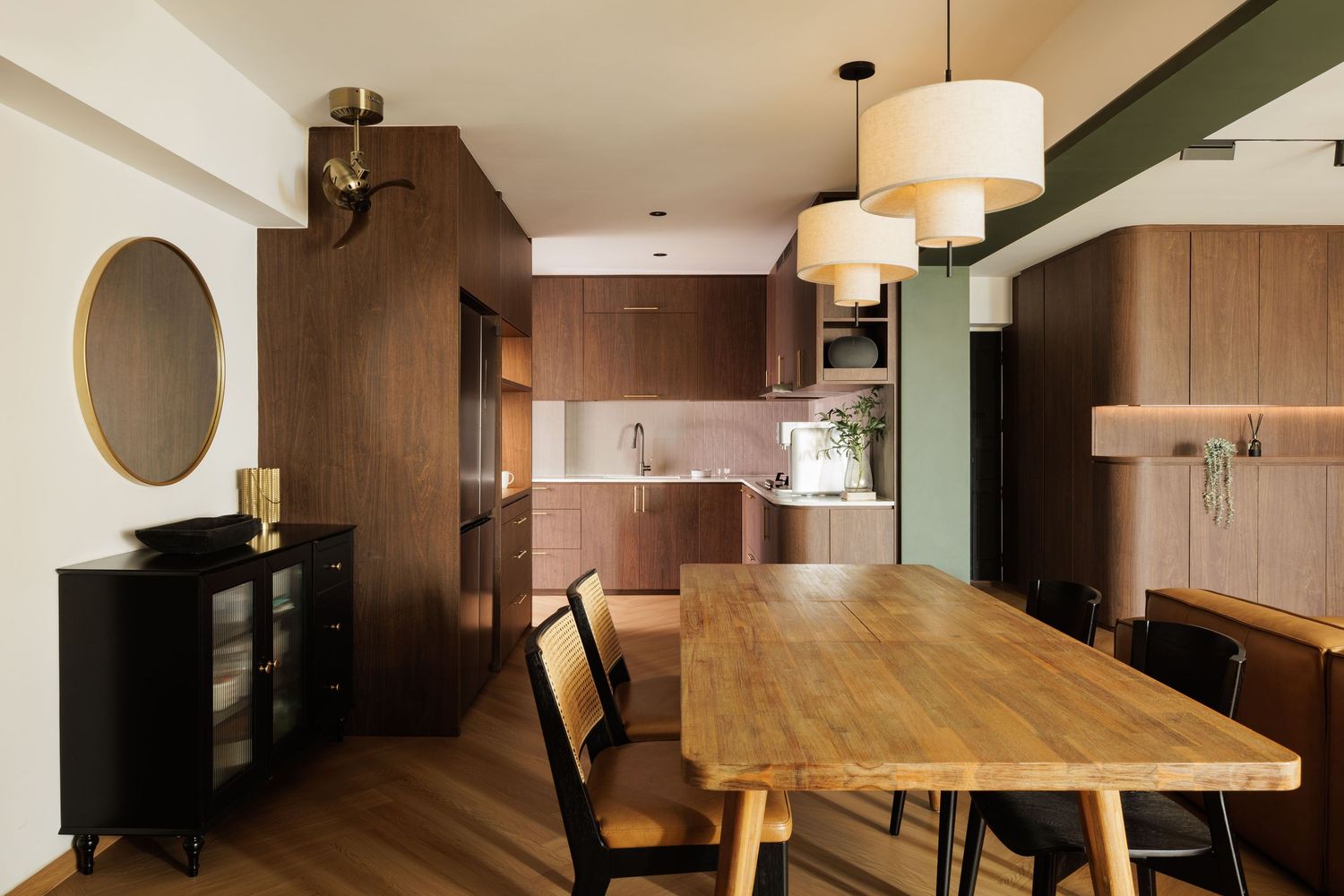 Modern restaurant interior with wooden tables, pendant lights, and sleek design elements creating a warm dining atmosphere.
