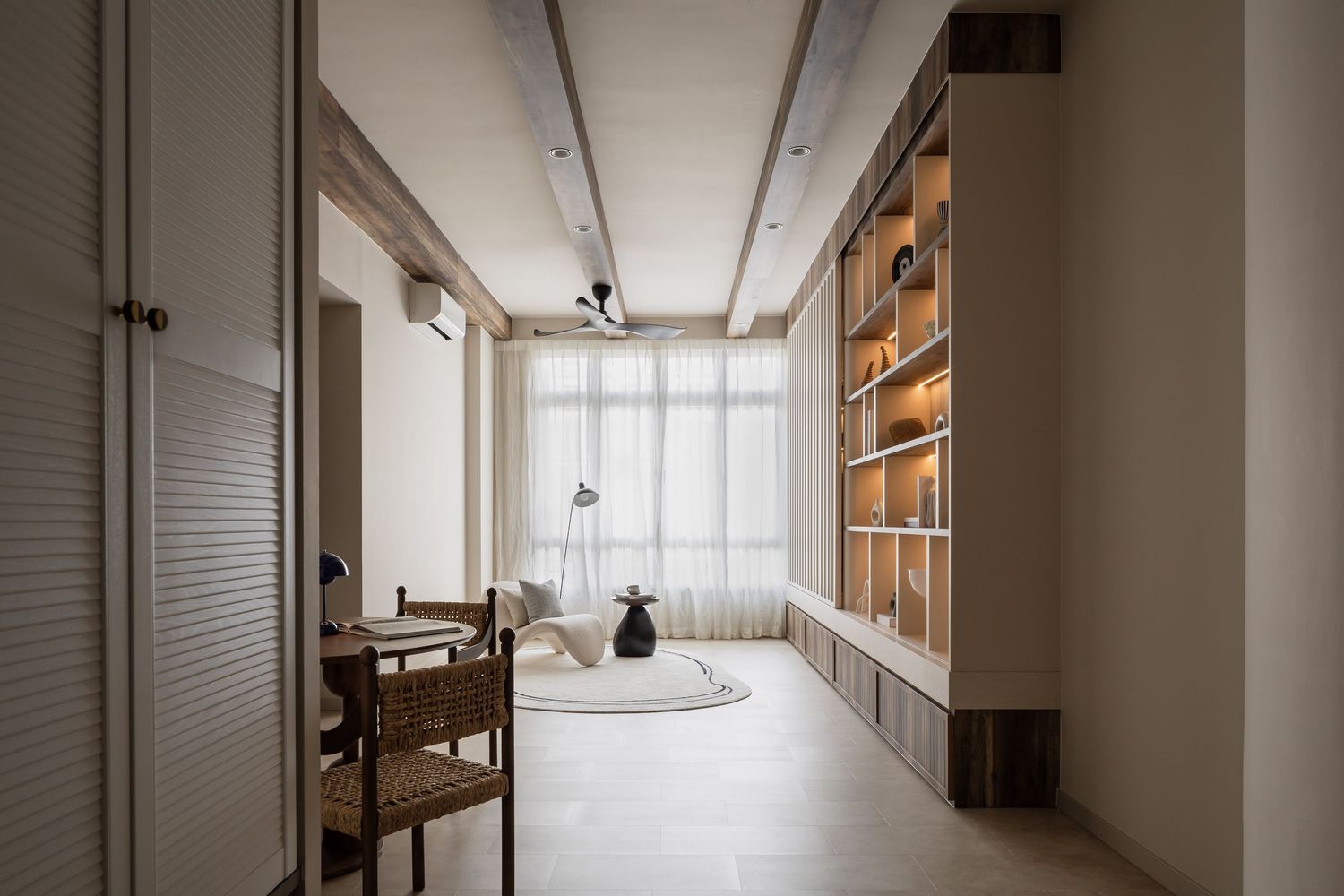 Modern minimalist hallway with built-in wooden storage shelves, white walls, and natural light coming through sheer curtains.