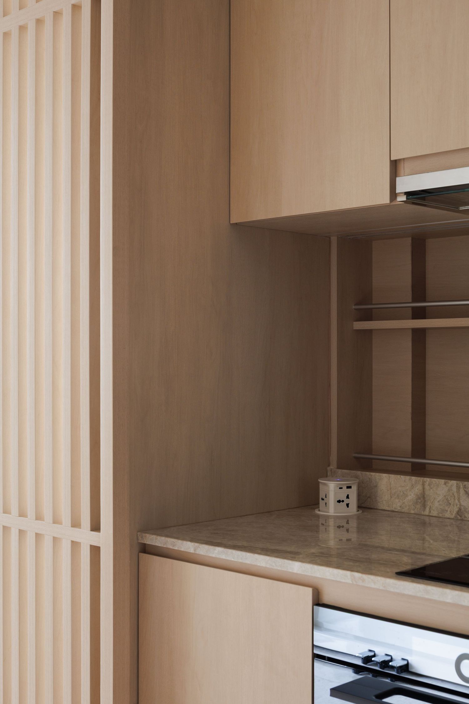 Interior view of modern beige closet system with built-in shelves and storage compartments.
