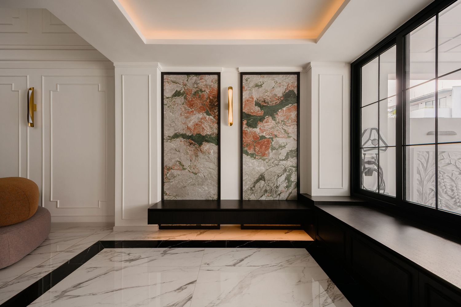 Luxury entryway with white marble flooring, black bench with warm lighting, two colorful abstract wall panels, and large black-framed window