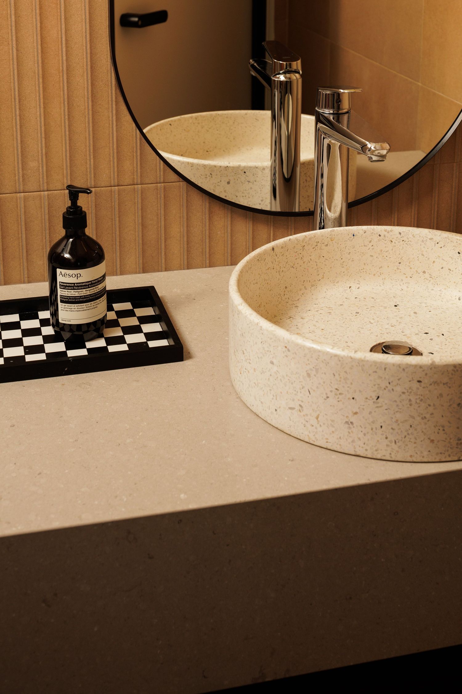A modern white speckled bathroom vanity countertop with chrome faucet fixtures shown in split panel view.
