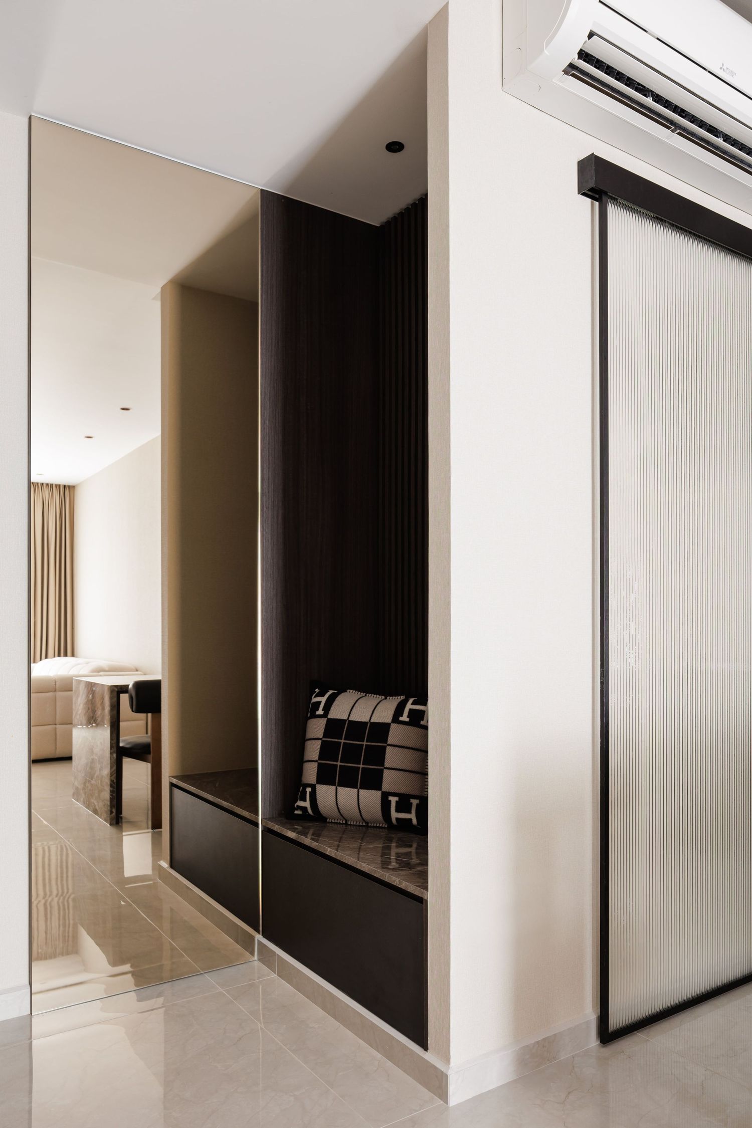 Modern minimalist interior hallway with white walls, light flooring and sleek black accent panels in a contemporary design.