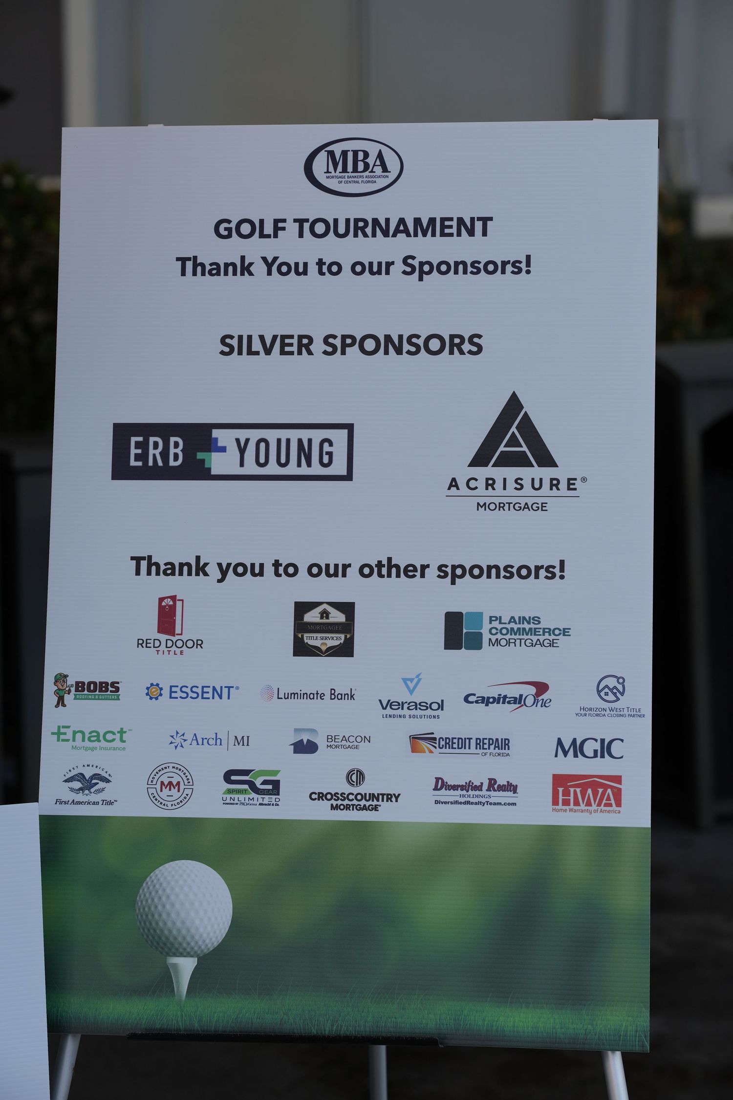 MBA Golf Tournament sponsor board listing Silver Sponsors ERB Young and Acrisure Mortgage.