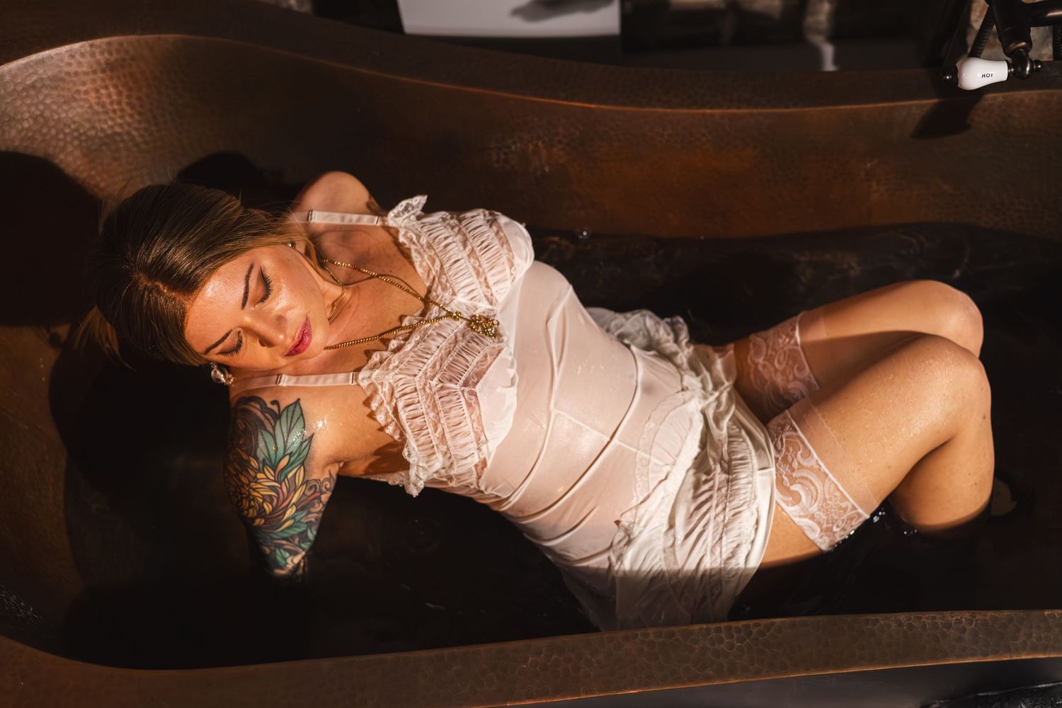 Intimate copper-tub boudoir portrait of Krys in soft warm light — photographed by Embodied By Matt in Medford, Oregon