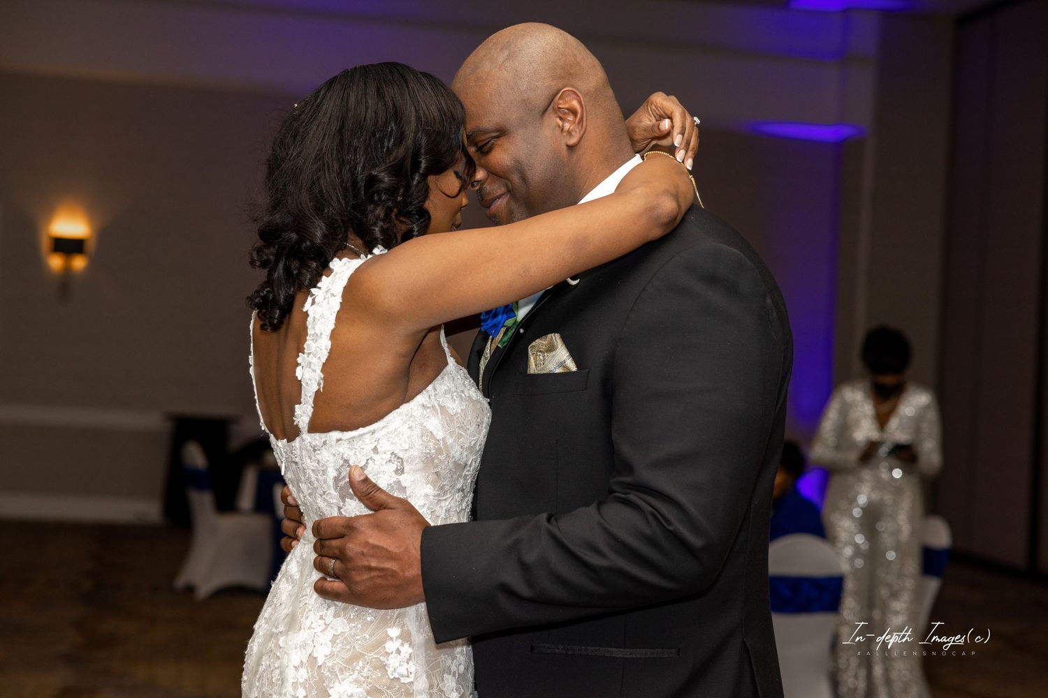 Newlyweds share an intimate first dance embrace at their elegant wedding reception.