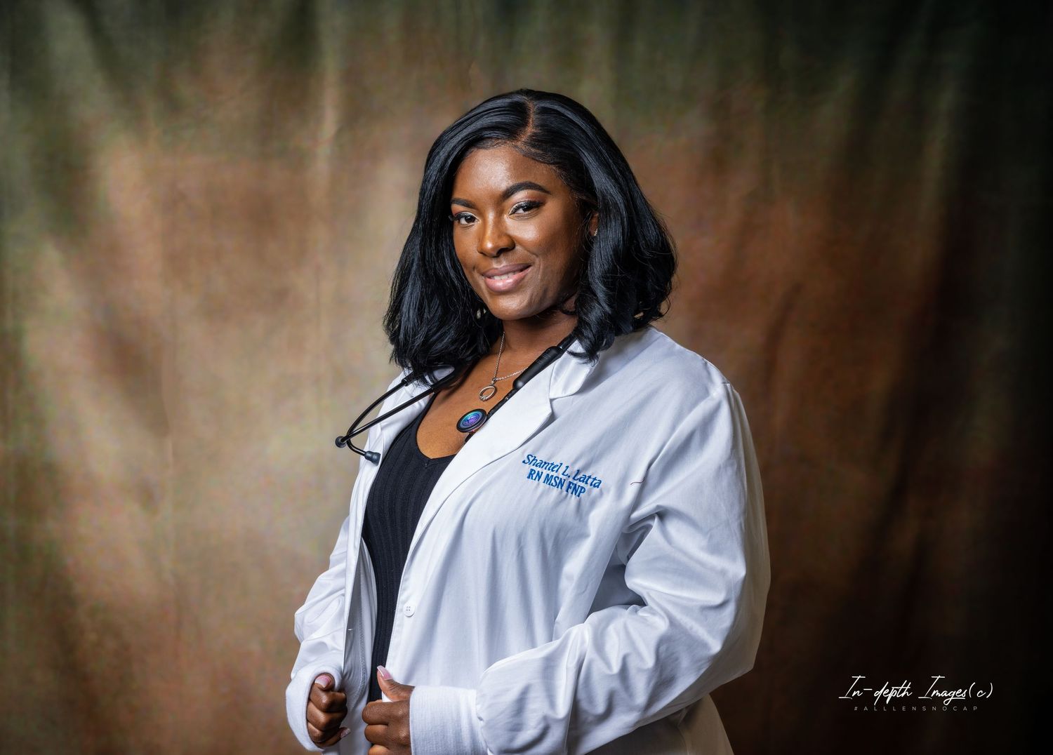 Woman in white medical coat smiling in professional portrait photo.
